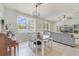 Dining area with table, chairs, chandelier, and a view of the living room at 4544 Point Look Out Rd, Orlando, FL 32808