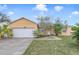 Charming one story home with a well maintained front yard and a two car garage at 4544 Point Look Out Rd, Orlando, FL 32808