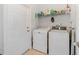 Functional laundry room with a washer, dryer, and storage shelf at 4544 Point Look Out Rd, Orlando, FL 32808