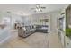 Spacious living room boasts a comfortable gray sofa, tile floors, and a seamless flow to the dining area at 4544 Point Look Out Rd, Orlando, FL 32808
