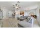 Inviting living area features an open floor plan with tile flooring, a ceiling fan, and a breakfast bar at 4544 Point Look Out Rd, Orlando, FL 32808