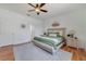Cozy main bedroom featuring a queen-sized bed, soft rug, ceiling fan, and neutral wall colors at 4544 Point Look Out Rd, Orlando, FL 32808
