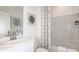Clean and bright bathroom with a shower and tub, along with a white vanity and decorative art at 4718 Yellow Elder Way, Kissimmee, FL 34758