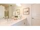 Beautiful bathroom with double sinks, white cabinets, and framed mirror; modern and elegant at 4718 Yellow Elder Way, Kissimmee, FL 34758