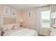Cozy bedroom with pink walls, plush bedding, window with curtains and decorations at 4718 Yellow Elder Way, Kissimmee, FL 34758