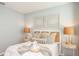 Well-lit bedroom featuring a cozy bed with decorative pillows and a window for natural light at 4718 Yellow Elder Way, Kissimmee, FL 34758