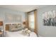 Cozy bedroom featuring neutral colors, a comfortable bed, and natural light from the window at 4718 Yellow Elder Way, Kissimmee, FL 34758
