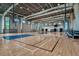 Spacious gymnasium with basketball hoops, clerestory windows, and a polished hardwood floor with court markings at 4718 Yellow Elder Way, Kissimmee, FL 34758