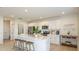 Bright kitchen featuring an island with seating, stainless steel appliances, and white cabinetry at 4718 Yellow Elder Way, Kissimmee, FL 34758