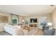 Spacious living room with neutral decor, comfortable seating, tile floors, and lots of natural light at 4718 Yellow Elder Way, Kissimmee, FL 34758