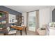 Stylish home office with wooden desk and shelving, a comfortable chair, and great natural light at 4718 Yellow Elder Way, Kissimmee, FL 34758