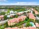 Scenic aerial view of the community featuring multiple buildings, a pool, small pond, and a lake surrounded by trees and greenery at 5160 Conroy Rd # 1423, Orlando, FL 32811