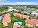 An aerial view captures the stunning community layout, featuring multiple buildings, a pool, and scenic water views at 5160 Conroy Rd # 1423, Orlando, FL 32811