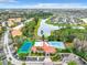 Overhead shot of the community clubhouse, tennis court, pool, and parking surrounded by a scenic lake and trees at 5160 Conroy Rd # 1423, Orlando, FL 32811