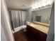 Bathroom with a shower-tub combination, granite vanity top, and a large mirror at 5160 Conroy Rd # 1423, Orlando, FL 32811