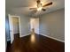 This bedroom features a ceiling fan, walk in closet and hard surface floors at 5160 Conroy Rd # 1423, Orlando, FL 32811