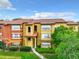 Exterior view of the apartments showing the balconies and architectural details with green landscape at 5160 Conroy Rd # 1423, Orlando, FL 32811