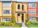 Exterior of the apartment building featuring balconies, landscaping, and a well-maintained walkway at 5160 Conroy Rd # 1423, Orlando, FL 32811