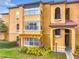 Apartment building exterior with architectural details, balconies, and lush landscaping at 5160 Conroy Rd # 1423, Orlando, FL 32811