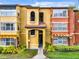 Exterior of the apartment building featuring balconies, landscaping, and a well-maintained walkway at 5160 Conroy Rd # 1423, Orlando, FL 32811
