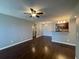 Open living area with a ceiling fan, neutral paint, and an opening to the kitchen at 5160 Conroy Rd # 1423, Orlando, FL 32811