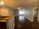 Living area with hardwood floors showing eat in kitchen bar and view to the outside at 5160 Conroy Rd # 1423, Orlando, FL 32811