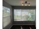Bright living space with large windows showcasing serene outdoor views and dark laminate flooring at 5160 Conroy Rd # 1423, Orlando, FL 32811