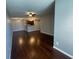 Open-concept space with wood floors, ceiling fan, and a view into the kitchen at 5160 Conroy Rd # 1423, Orlando, FL 32811