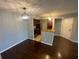 Open-concept dining and kitchen area with modern lighting, hardwood floors, and stainless appliances at 5160 Conroy Rd # 1423, Orlando, FL 32811