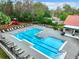 A large community pool featuring plenty of lounge chairs and greenery to enjoy on a sunny day at 5160 Conroy Rd # 1423, Orlando, FL 32811