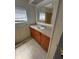Bathroom with wooden cabinets, white sink, and tile flooring at 551 Pine Needle Ct, Lake Mary, FL 32746