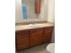 Bathroom with wooden cabinets, white sink, and tile flooring at 551 Pine Needle Ct, Lake Mary, FL 32746