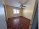 Bedroom with paneled walls, a ceiling fan, and hardwood flooring at 551 Pine Needle Ct, Lake Mary, FL 32746