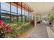 Exterior view of a community building with floor to ceiling windows, a covered walkway, and lush landscaping at 551 Pine Needle Ct, Lake Mary, FL 32746