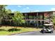 Beautiful community building with lush landscaping, a modern design, and a golf cart parked out front at 551 Pine Needle Ct, Lake Mary, FL 32746