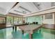 Bright game room featuring billiard tables, natural light from large windows, and a nature themed wall at 551 Pine Needle Ct, Lake Mary, FL 32746