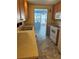A kitchen featuring wood cabinets, double basin sink, and appliances on tile flooring at 551 Pine Needle Ct, Lake Mary, FL 32746