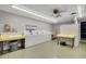 Brightly lit laundry room featuring multiple washing machines and folding tables for residents' convenience at 551 Pine Needle Ct, Lake Mary, FL 32746