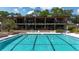 Relaxing view of a clean swimming pool with striped lane lines outside a well-maintained community building at 551 Pine Needle Ct, Lake Mary, FL 32746