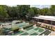 Aerial view of the shuffleboard and miniature golf facility within the community, surrounded by trees at 551 Pine Needle Ct, Lake Mary, FL 32746