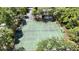 Aerial view shows the community tennis courts, surrounded by trees, offering a private recreational space at 551 Pine Needle Ct, Lake Mary, FL 32746