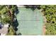 Aerial view shows the community tennis courts, surrounded by trees, offering a private recreational space at 551 Pine Needle Ct, Lake Mary, FL 32746