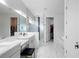 Bright primary bathroom featuring a marble shower, dual vanities, and a soaking tub at 5511 Orange Orchard Dr, Winter Garden, FL 34787
