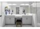 Elegant bathroom featuring double sinks, a vanity area, and a tiled shower at 5511 Orange Orchard Dr, Winter Garden, FL 34787