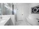 Bright bathroom showcasing marble floors, a soaking tub, and a glass-enclosed shower at 5511 Orange Orchard Dr, Winter Garden, FL 34787