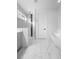 Modern bathroom featuring marble floors, a glass shower, and a standalone bathtub at 5511 Orange Orchard Dr, Winter Garden, FL 34787