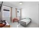Cozy bedroom with a twin bed, natural light, and a simple, clean design at 5511 Orange Orchard Dr, Winter Garden, FL 34787