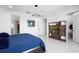 Spacious primary bedroom featuring tile floors, a TV, and access to a walk-in closet at 5511 Orange Orchard Dr, Winter Garden, FL 34787