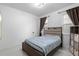 Bright bedroom with a queen-sized bed, modern lighting, and neutral decor at 5511 Orange Orchard Dr, Winter Garden, FL 34787