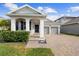 Charming single-Gathering home featuring a two-car garage and covered entryway at 5511 Orange Orchard Dr, Winter Garden, FL 34787